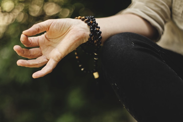 closeup of hand in meditation pose